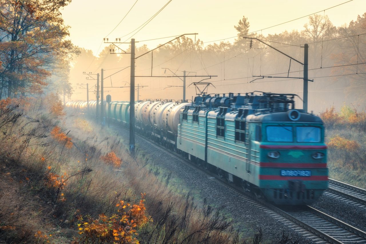 Moving Freight Train In Beautiful Forest In Fog